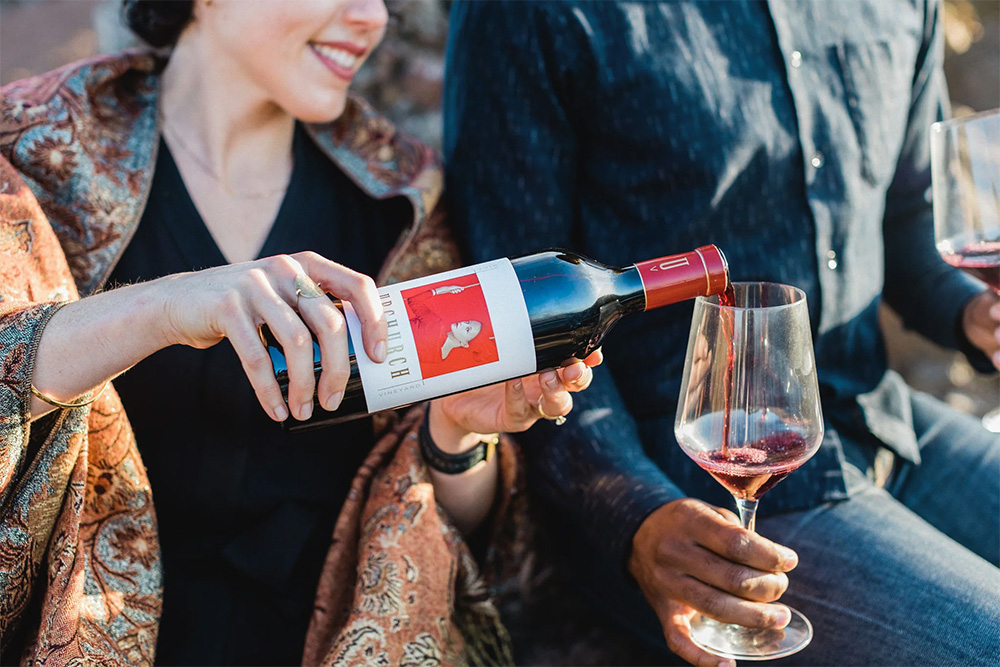 Woman pouring a glass of red wine