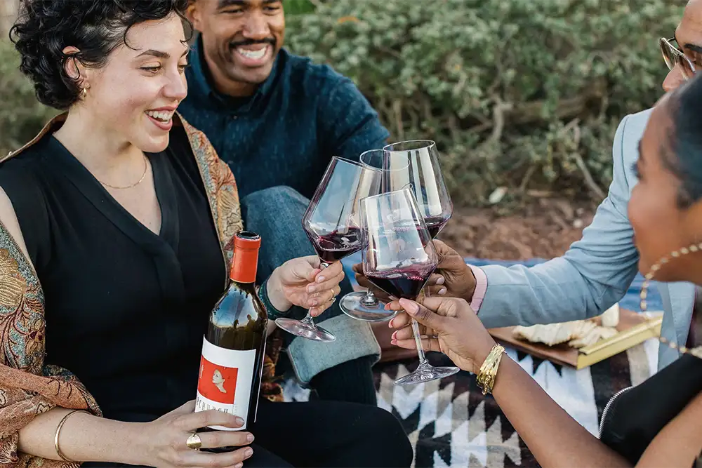 People drinking red wine at the Upchurch club release party